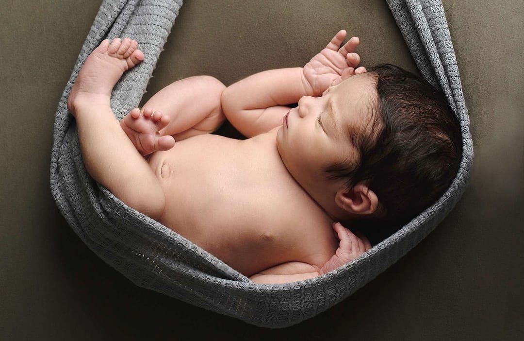 baby boy in sling on jade blanket taken by Burgess Hill photographer