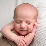 smiling newborn baby during professional baby photoshoot in west sussex