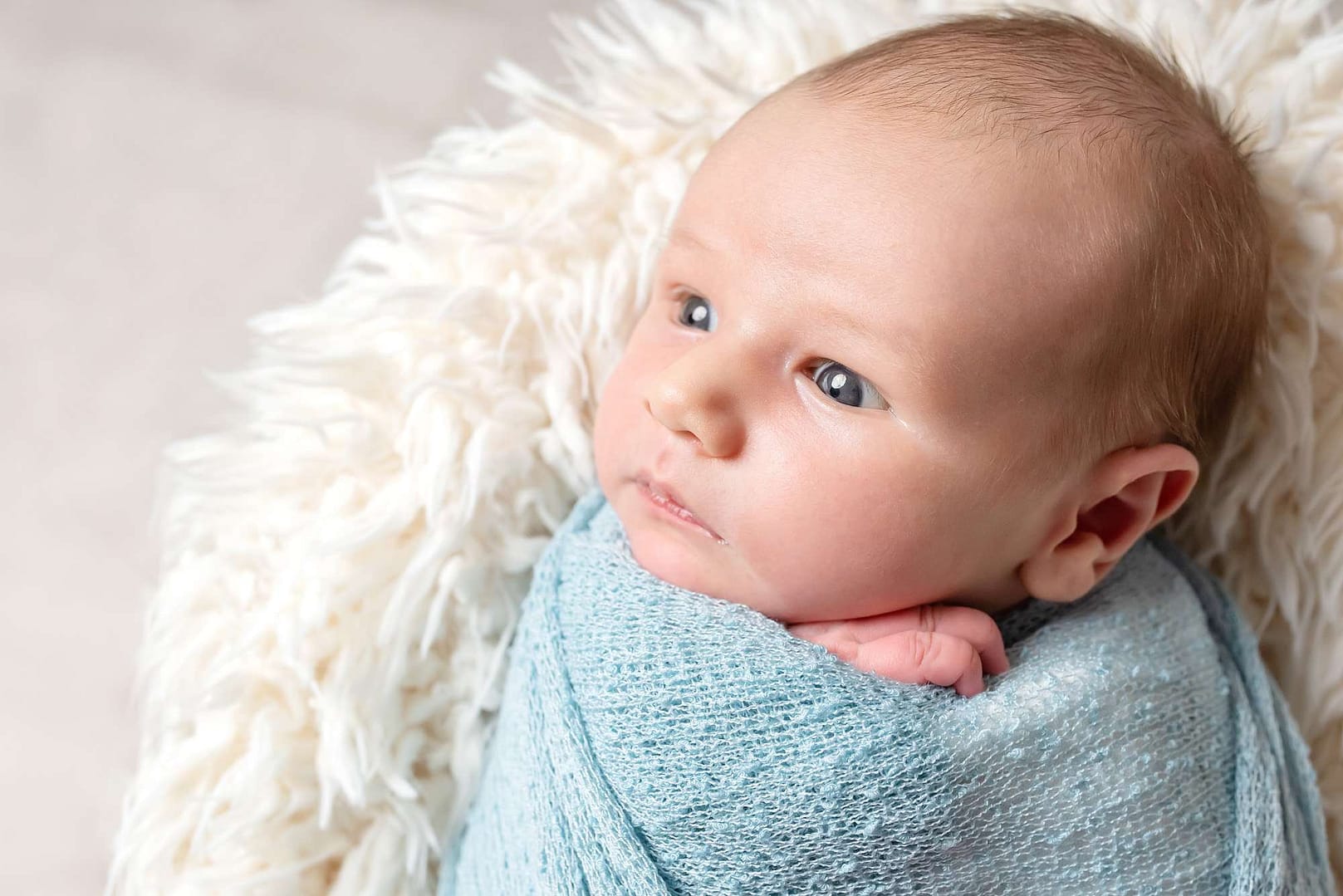 wide awake newborn baby taken during professional photoshoot in west sussex