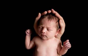Baby Girl held in Daddys hands