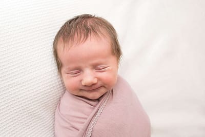 photo of baby girl by best newborn photographer west sussex